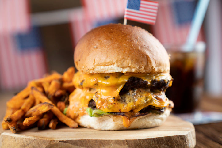 Two stacked grassfed burgers with melted cheese, made from single-animal ground beef from Tyner Pond Farm