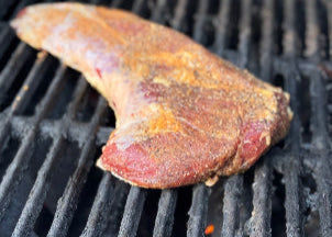 Tri-tip on a grill with visible grill marks