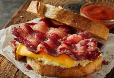 Side view of bacon, egg, and cheese breakfast sandwich using Tyner Pond Farm bacon