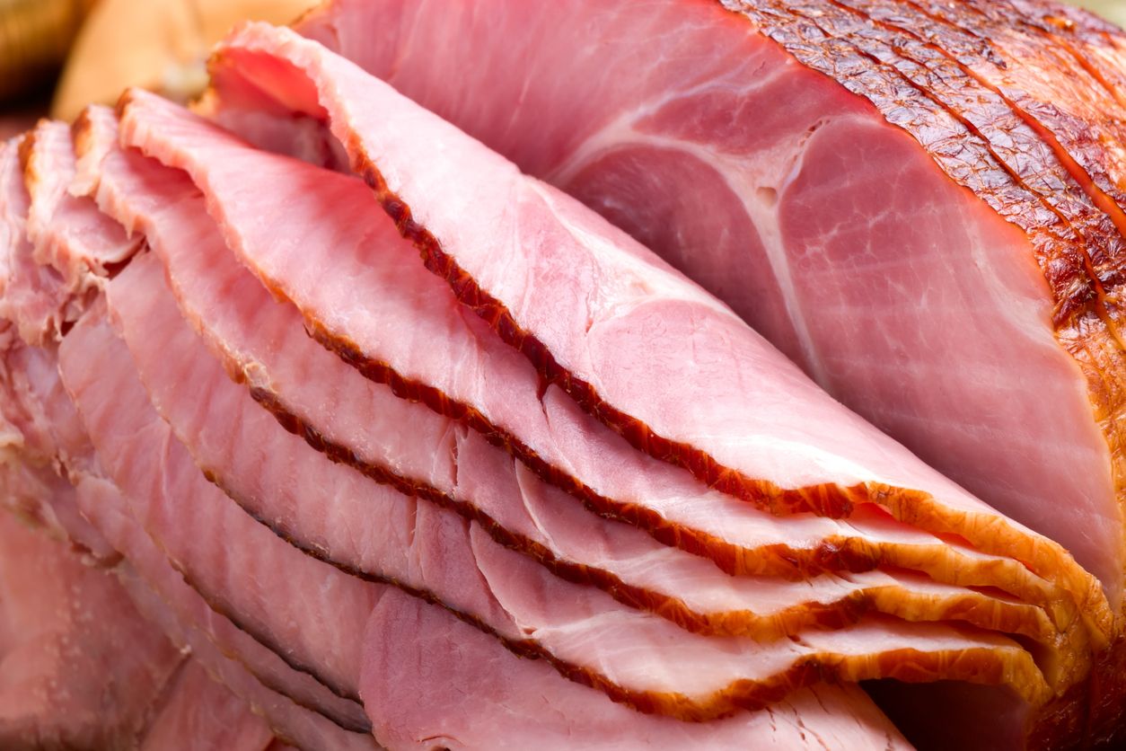 Close-up of boneless smoked ham slices showing texture and interior color