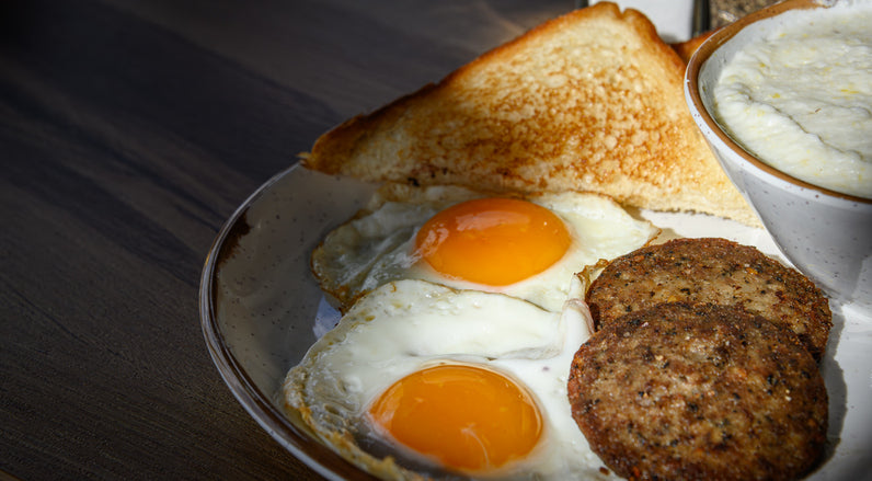 Breakfast plate with eggs and cooked breakfast sausage made from pastured pork