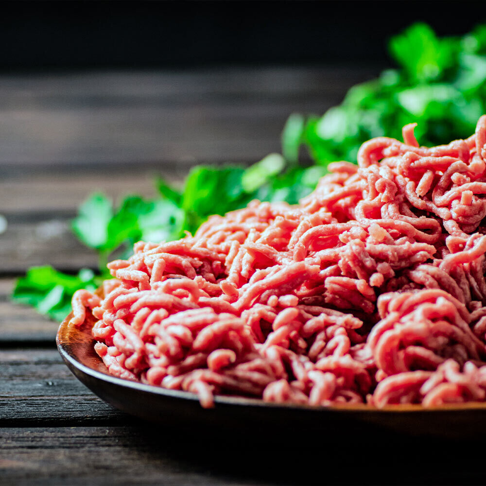 Grassfed ground beef on a platter near open fire, raised on pasture at Tyner Pond Farm in Indiana