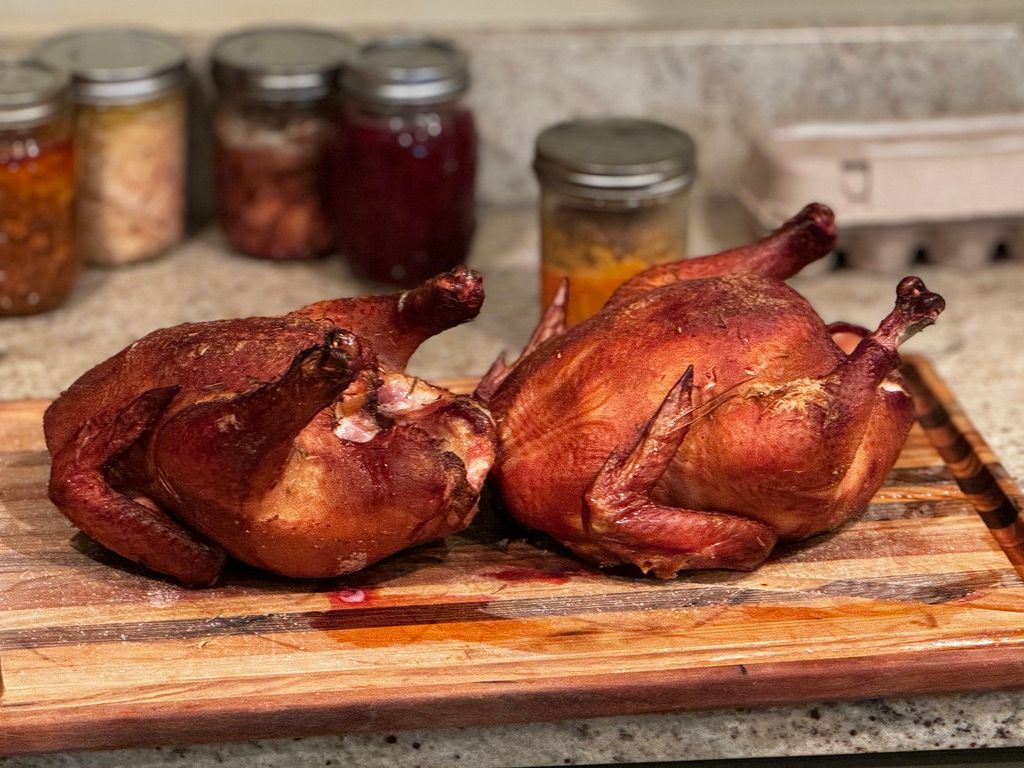 Evenly browned whole chicken, pasture-raised and roasted whole on cutting board