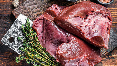 Raw grassfed beef heart on cutting board, from pasture-raised cattle at Tyner Pond Farm