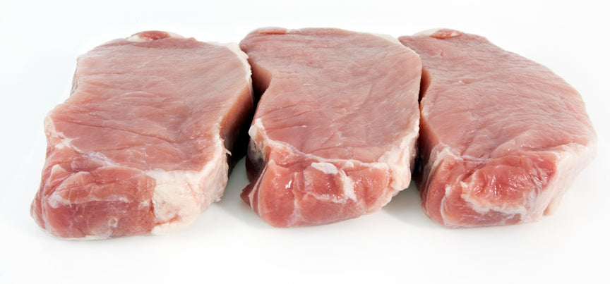 Side view of three raw boneless pork chops on white background, ready to coo