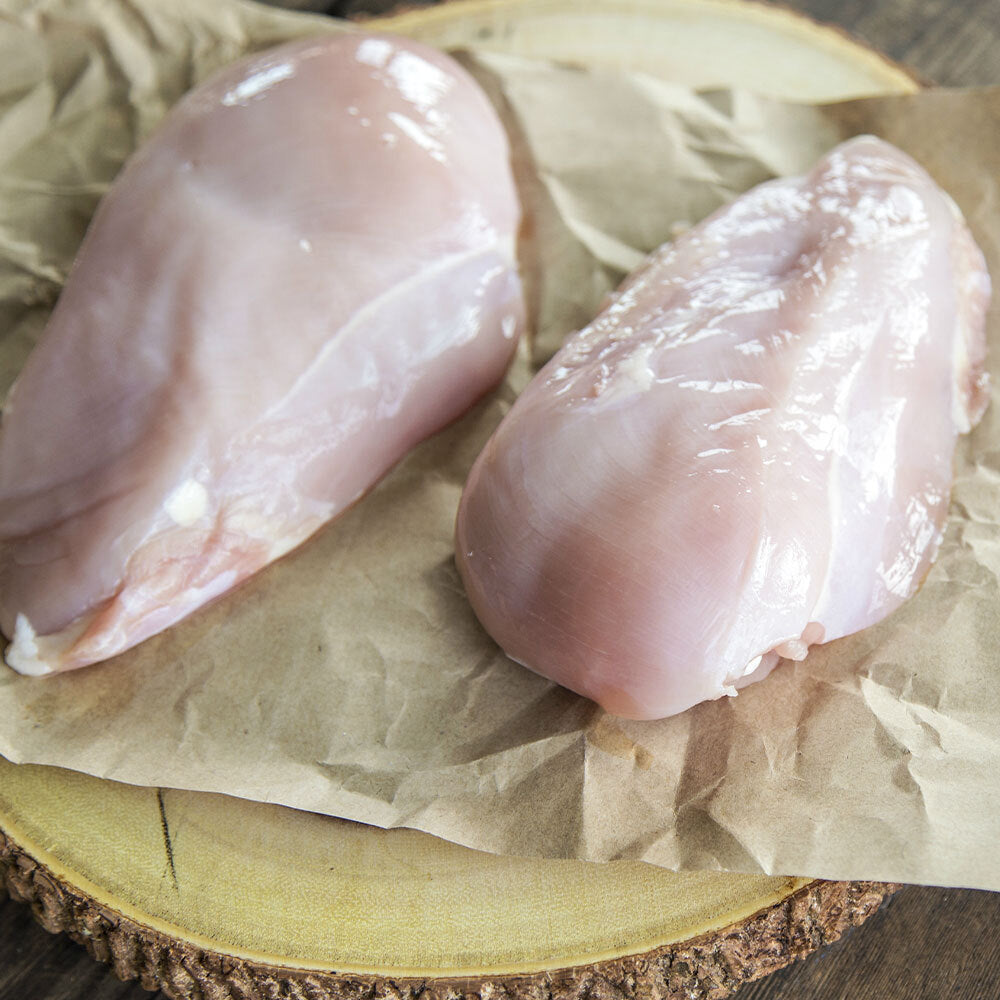 Two raw boneless skinless chicken breasts from pasture-raised birds at Tyner Pond Farm