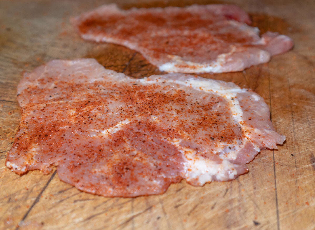 Raw cubed pork tenderloin on butcher paper, ready to cook