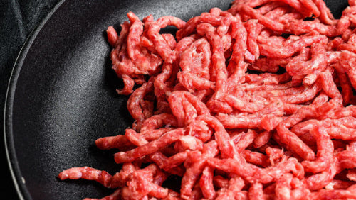 Raw grassfed ground beef in cast iron skillet, raised on pasture at Tyner Pond Farm