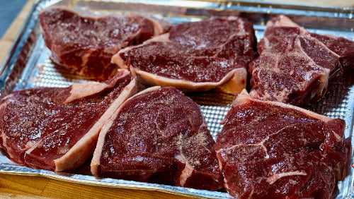 Raw sirloin steak on metal tray, lean cut from grassfed cattle in Indiana