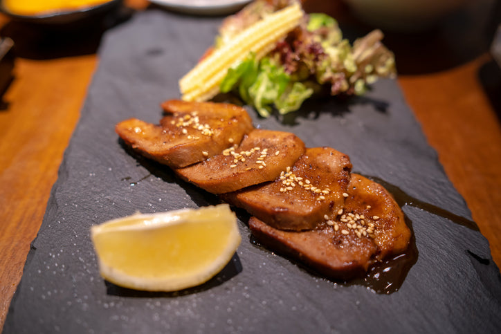 Thin-sliced beef tongue Japanese-style on platter, prepared from grassfed beef