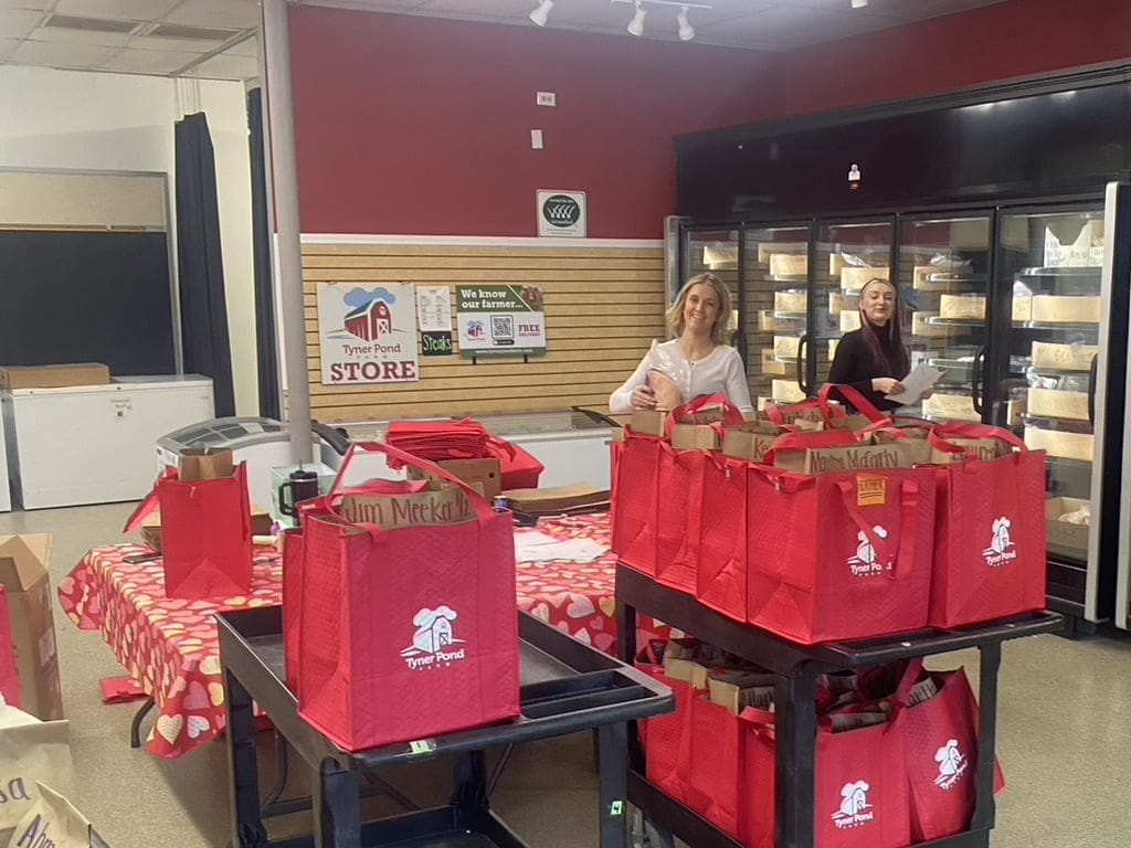 Women preparing orders at Tyner Pond Farm Store, showcasing local and sustainable products.