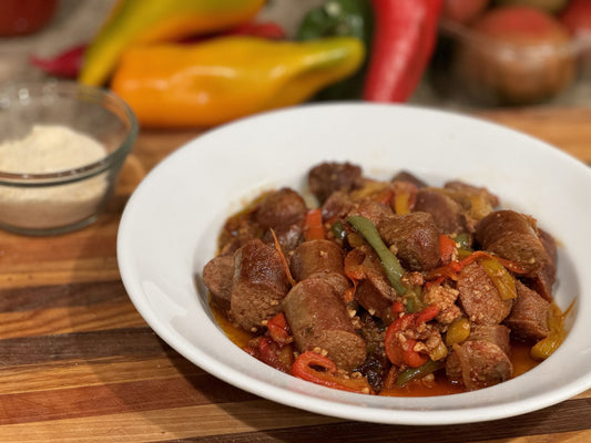 Plate of rustic sausage and peppers made with pasture-raised Italian sausage, bell peppers, and onions.