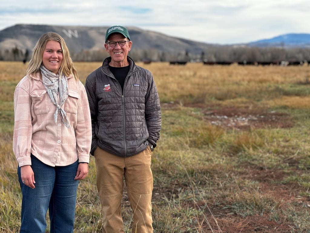 Cloe Parker, young CEO of Parker Pastures in Gunnison, Colorado, standing with a visitor in her high mountain pasture, committed to regenerative and holistic ranching practices.
