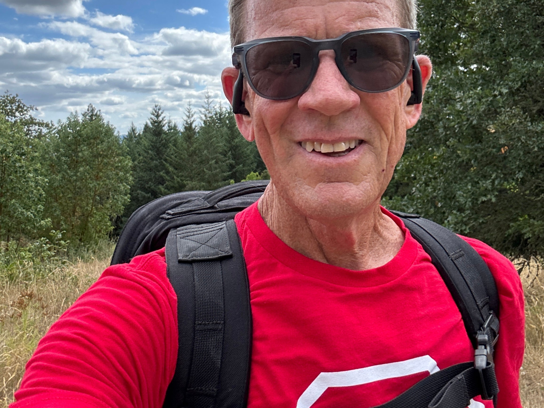 Man rucking with backpack on forest trail for fitness and longevity