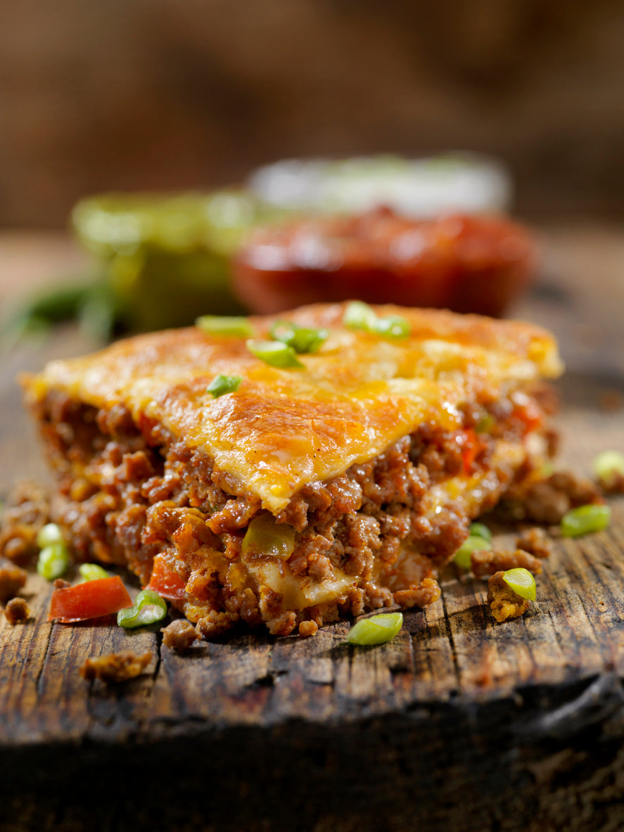 baked layered beef taco pie with sour cream salsa and guacamole made with grassfed beef from Tyner Pond Farm