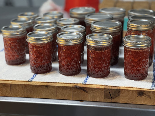 Jars of jam cooling on a countertop