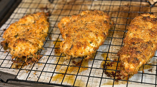Crispy keto Caesar chicken cutlets made with Tyner Pond Farm pasture-raised chicken breast, Parmesan, herbs, and a golden pork-rind crust.