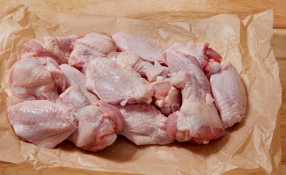 Raw chicken wings prepared for feeding as part of a biologically appropriate raw food (BARF) diet for dogs.