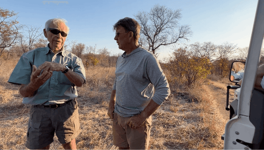 Alan Savory and Chris Baggott studying holistic management practices in an open field in Zimbabwe