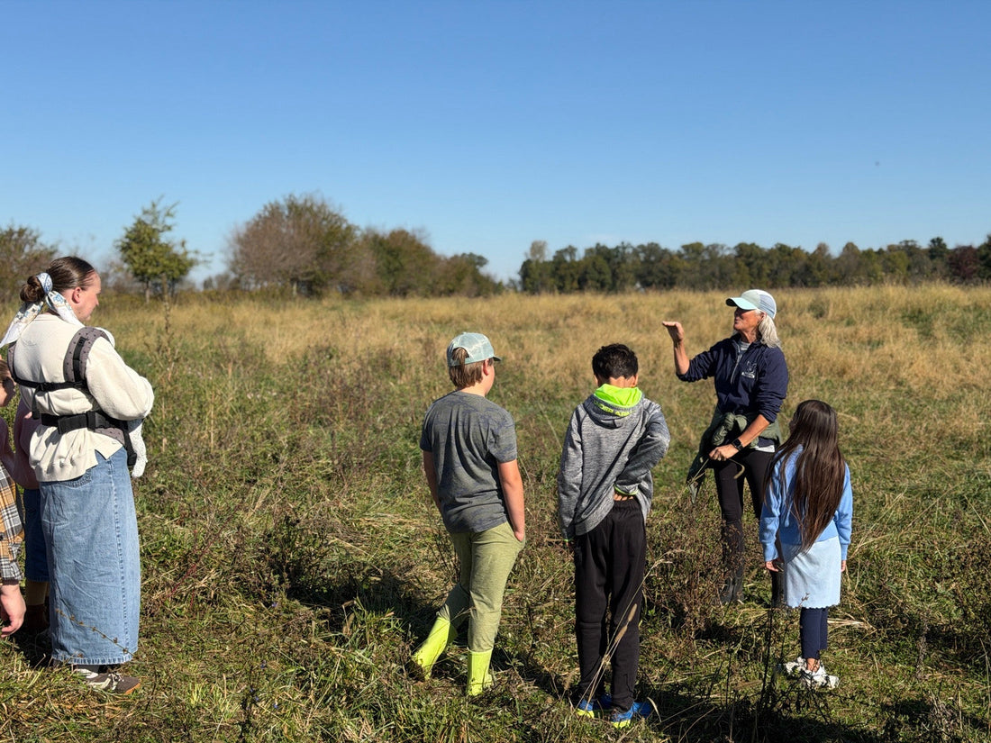 Amy Baggott speaking with a homeschool group in a pasture at Tyner Pond Farm.