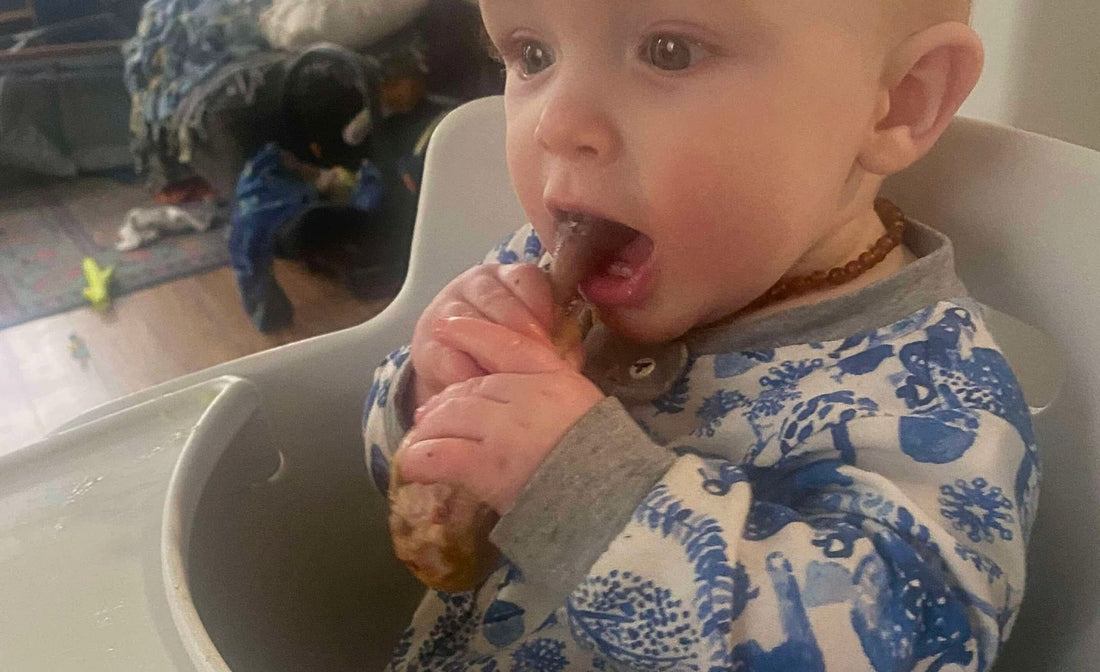Baby exploring real food during baby-led weaning, early diet supporting developing gut microbiome.