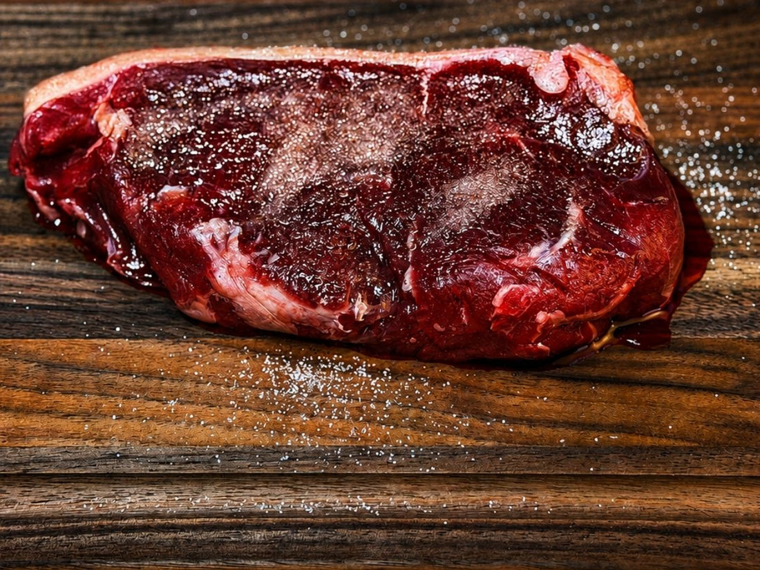 Grass-fed steak seasoned with salt for a 12-hour dry brine before cooking at Tyner Pond Farm