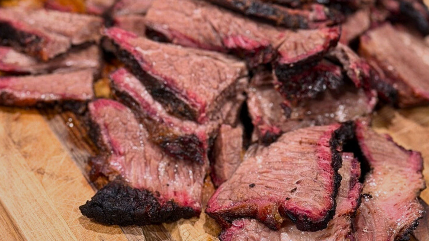 Sliced grass-fed brisket smoked on a standard gas grill using the two-zone method.