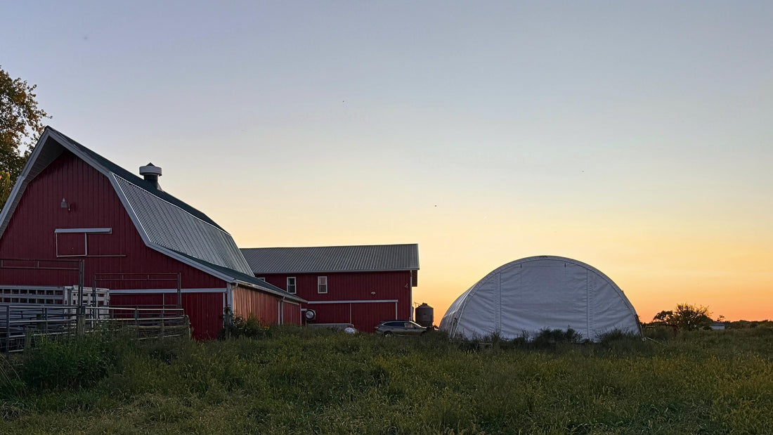 Red barn and hoop house at sunset on Tyner Pond Farm, illustrating the Indiana rural landscape protected by SEA 1 legislation