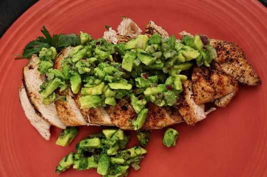 Grilled Tyner Pond Farm chicken topped with chopped avocado herb salsa.