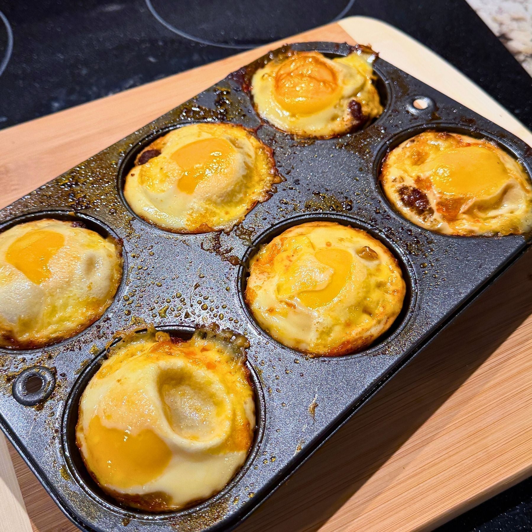 Baked egg cups made with Tyner Pond Farm chorizo and pasture-raised eggs in a muffin tin.