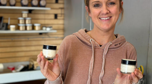 Kristen holding small batch grass fed beef tallow moisturizer made at Tyner Pond Farm