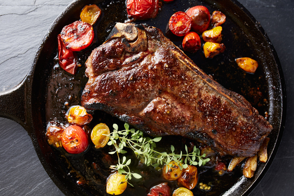Grassfed steak cooking in cast iron skillet, sourced from Tyner Pond Farm in Greenfield, Indiana