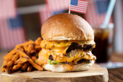 Two stacked grassfed burgers with melted cheese, made from single-animal ground beef from Tyner Pond Farm