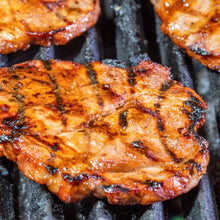 Close-up of grilled meat with grill marks on a grill