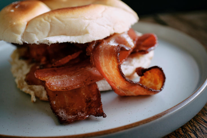 Overflowing breakfast sandwich with crispy bacon, egg, and cheese