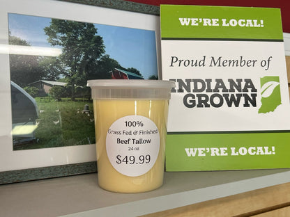 A container of beef tallow on a shelf with a price tag, in front of signs stating 'We're Local' and 'Proud Member of Indiana Grown'.