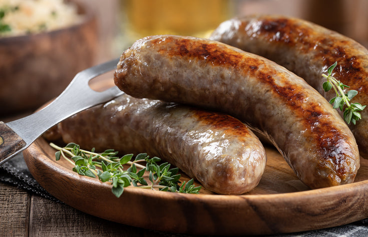 Plate of roasted bratwurst soaked in beer, ready to serve