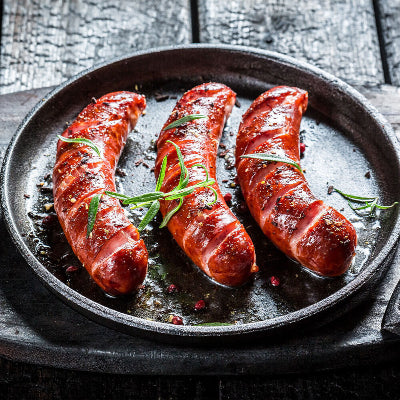 Buffalo blue cheese sausages grilled and served on a platter, pork brats with visible sear