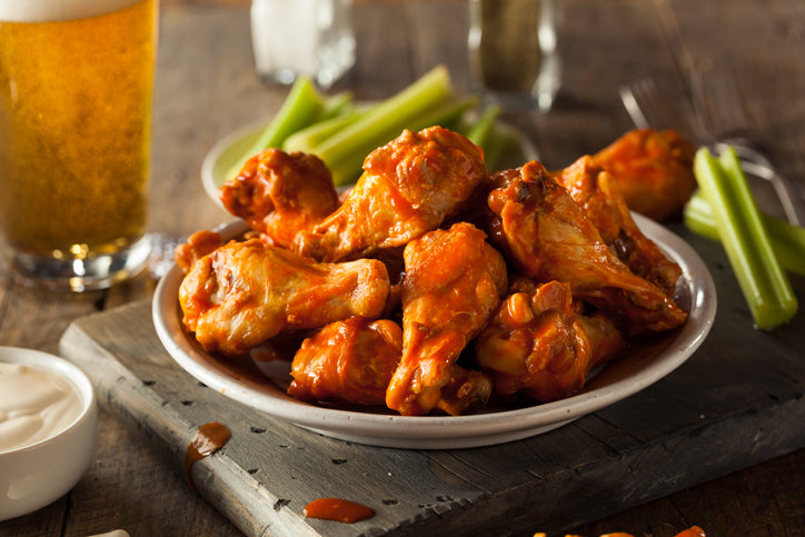 Buffalo chicken wings made from pasture-raised poultry, tossed in sauce and served in bowl