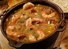 Cajun gumbo with sausage and seafood simmering in a Dutch oven