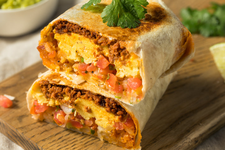 Breakfast burrito cut in half showing chorizo, eggs, and cheese