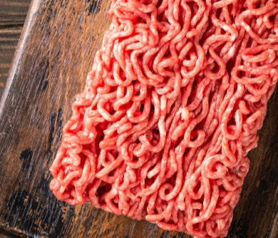 Close-up of grassfed ground chuck showing visible fat content, from pasture-raised beef