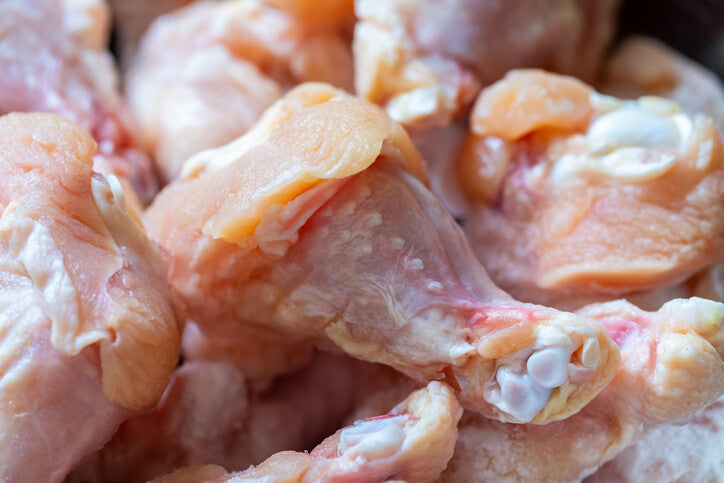 Close-up of raw pasture-raised chicken wings with skin and joints visible, from Tyner Pond Farm