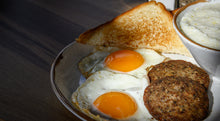 Breakfast plate with eggs and cooked breakfast sausage made from pastured pork