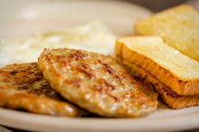 Cooked sausage patties served with toast, made from local pork breakfast sausage