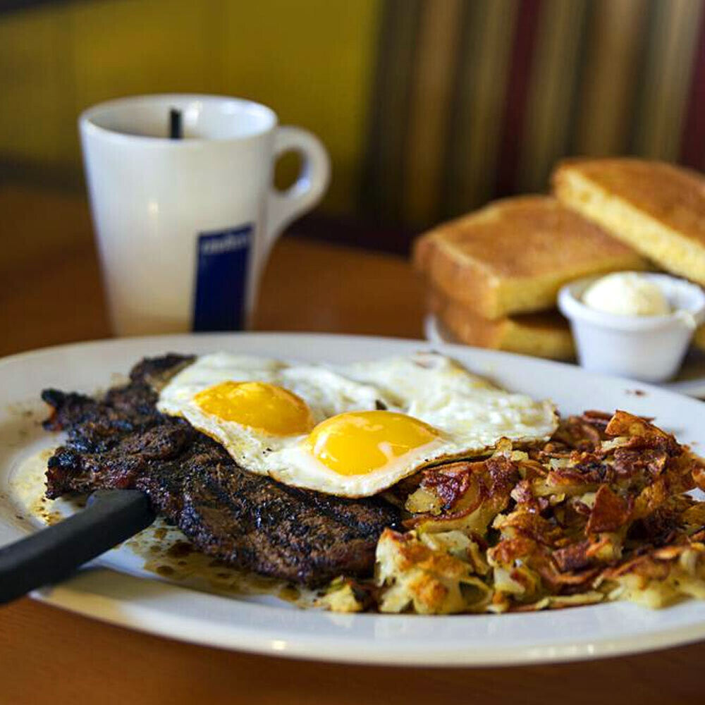 Thin-cut grassfed ribeye steak plated with eggs and hashbrowns, raised on pasture at Tyner Pond Farm