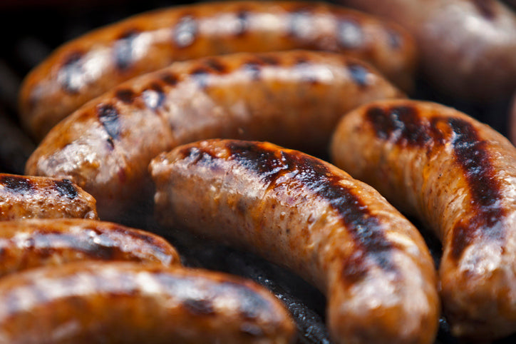 Pile of grilled hot Italian sausage links, browned and ready to serve