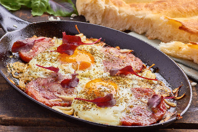 Platter of sliced ham served with eggs, ready to eat