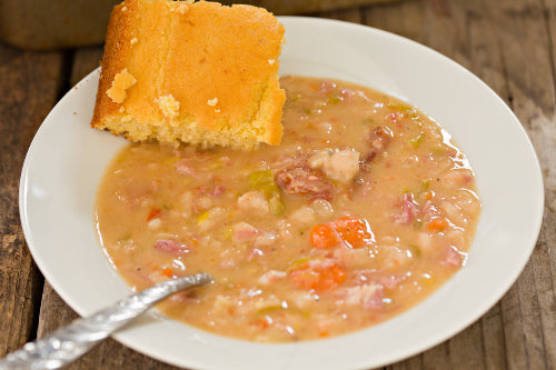 Ham and bean soup with diced ham pieces in broth, ready to serve