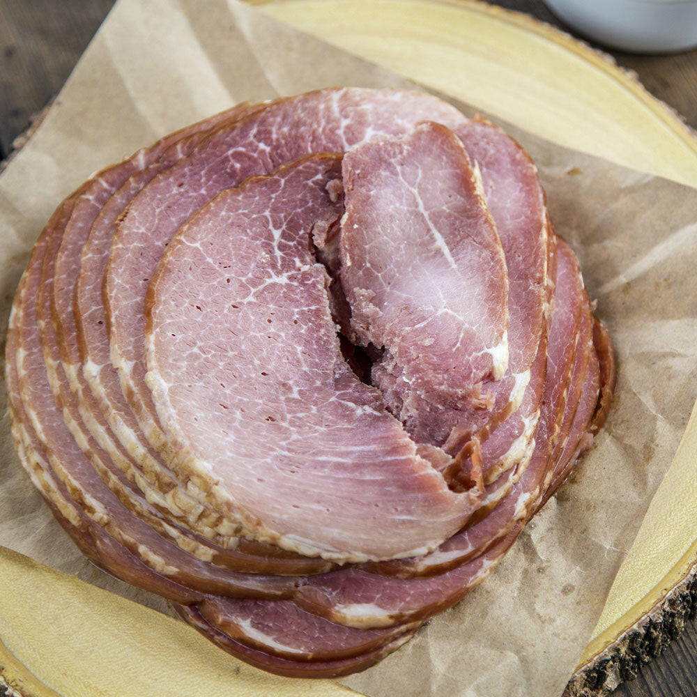 Top-down view of packaged ham slices on butcher paper, uncured and frozen
